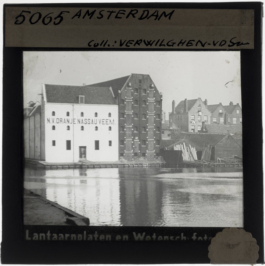 Amsterdam. Rear view of the warehouses of N.V. Leydsche - Oranje Nassau Veem and warehouse Prinses Beatrix, seen from the Zoutkeetsgracht. - KU Leuven. Glass slides landscape, architecture and design. Université de Louvain, between 1839 and 1939. Photographer unknown. Added information on slide. Current location: Netherlands, Amsterdam, Vierwindenstraat. Creation/Building: 1898. EuroPhot. Art History. 19th century. Architecture. Building. EuroPhot. Art history. 19th century. Architecture. Building. EuroPhot. Social history. 19th century. Architecture. Building. EuroPhot. Social history. 19th century. Architecture. Building.