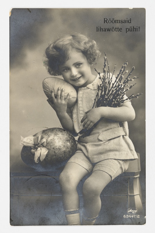 Lihavõttekaart munade ja pajuokstega lapsega ning tekstiga "Rõõmsaid lihavõtte pühi"