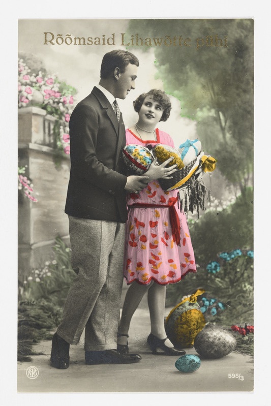 Romantiline koloreeritud lihavõttekaart värvilisi mune kandva naise ja mehega ning tekstiga "Rõõmsaid Lihavõtte pühi"