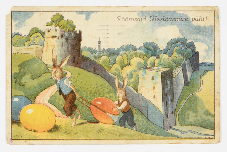 Lihavõttekaart värvilisi mune transportivate jänestega Petseri kloostri taustal