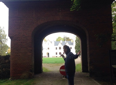 Alatskivi Manor Gate and Manor Building. In front of the brickstone wall and gate. See the main building behind the gate opening. rephoto