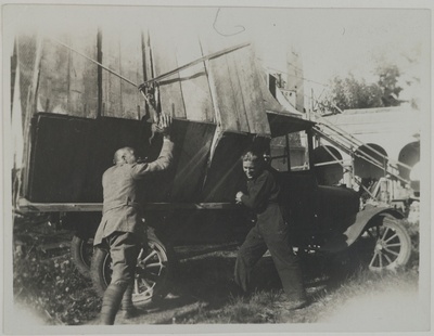 Studies for the Kalevala frescoes ready to be transported from Tarvaspää to the National Museum of Finland, Akseli Gallen-Kallela with another man by the car, 1928. Print 1 of the picture 1.  duplicate photo