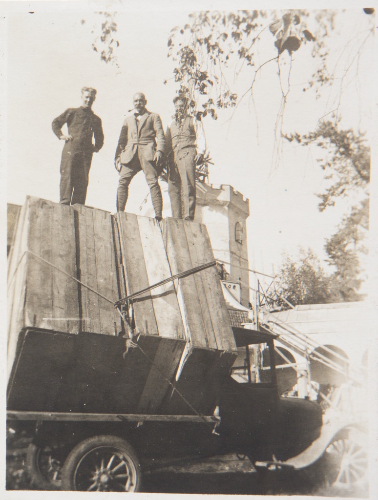 Studies for the Kalevala frescoes ready to be transported from Tarvaspää to the National Museum of Finland; Akseli and Jorma Gallen-Kallela and Yrjö Lampila staying on the load, 1928; print 2 of the photograph.