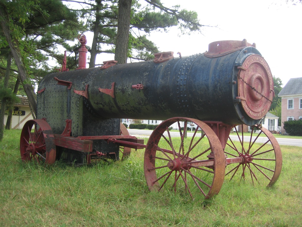 Frick Portable Engine 002 - Portable Steam Engine manufactured by Frick Company Engineers.  It is located at the "Y" intersection of Ridge Road and Bunting Road on Chincoteague Island, Virginia.  The address of the building next to this steam engine is 3625 Ridge Road.  The front end of the chassis has "Frick Company Engineers", "Patented Jan 10, 1882", "1243A", "Waynesboro, PA".