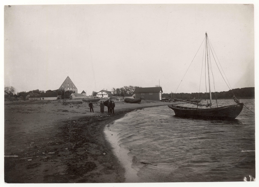 Fishermen's family at their boat on the eastern shore of the River Pirita. Western view of the Pirita monastery Church in the back of the edge of the W