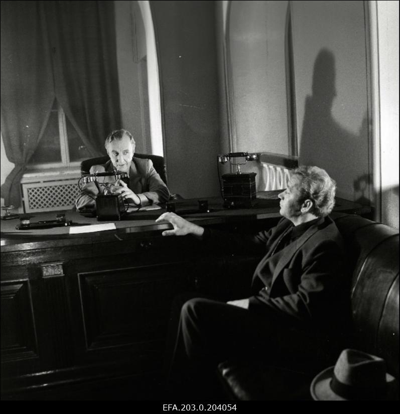 Stseen Tallinnfilmi mängufilmist "Bande". Istuvad Paul Madving (Aarne Üksküla) ja Ned Beamount (Tõnu Kark).