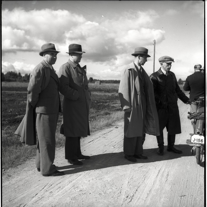 Mehed seismas maanteel, kõrval mootorratas
