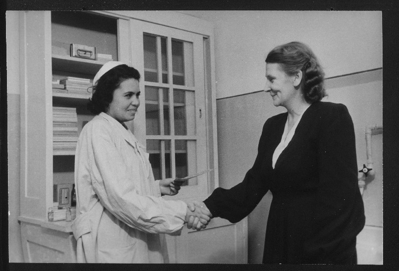 Maardu Keemiakombinaadi arstiabipunkti juhataja J. Draznina (vasakul) tervitab kombinaadi töötajat S. Karrot tagasisaabumise puhul puhkuselt Pärnu Sanatooriumist.