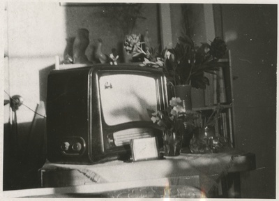 Sätitud kompositsioon: lauakese peal raadio iluasjadega, raadio kõrval vaasid lilledega  similar photo